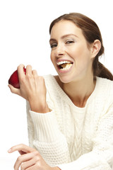 Beautiful woman eating an apple on a white background