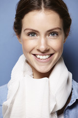 portrait of a young adult on blue background