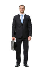 Full-length portrait of business man with case