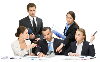 Group of executives debating while sitting at the table