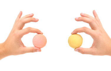 Hands holding macaron cake.