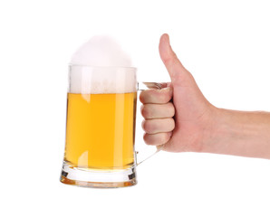 Mug of beer with foam in hand.