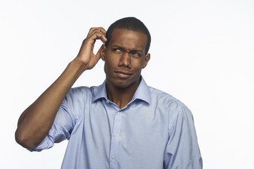 Young black man confused and scratching head, horizontal