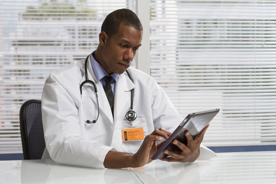 African American Doctor Holding Electronic Tablet, Horizontal
