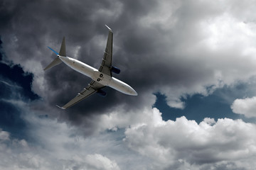Airplane at fly on the sky with clouds