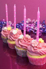 Pink birthday cupcakes with pink & purple decorations