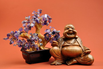 Laughing Buddha wood statue with amethyst tree