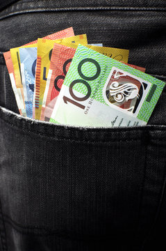 Australian money in black jeans back pocket