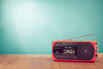 Retro red radio cassette player in front mint green background