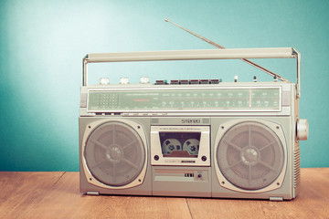 Retro ghetto blaster on table in front mint green background