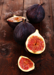 Ripe figs on wooden table close-up