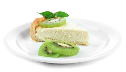 Slice of cheesecake with kiwi fruit on plate, isolated on white