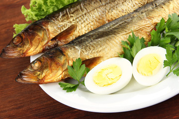 Smoked fish on plate close up