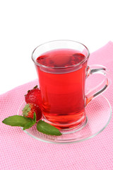Delicious strawberry tea on table on white background