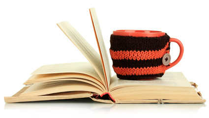 Cup with knitted thing on it isolated on white