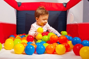 Baby playing with colorful balls