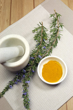 Rosemary and turmeric spice with mortar and pestle