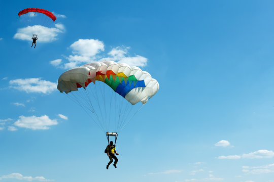 unidentified skydivers on blue sky