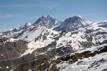 Fototapeta na wymiar Dom across snowfields at Gornergrat in Swiss Alps