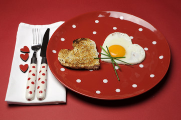 Red theme breakfast with heart shape egg and toast.