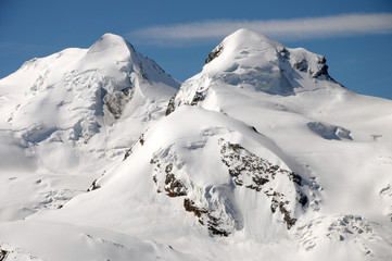 Fototapeta na wymiar Castor and Pollux across glacier at Gornergrat in Swiss Alps