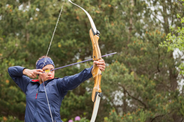 Concentrating brunette practicing archery
