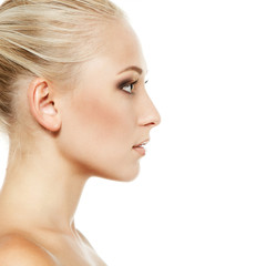 Fototapeta premium Beauty portrait of young smiling girl in proflile with blond hai
