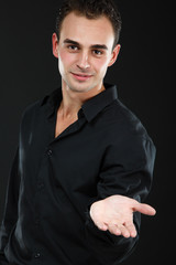 Obraz premium Young cheerful man in black shirt, portrait of attractive guy lo