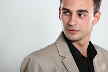 Trendy man in black shirt and beige jacket, portrait of sexy fas