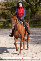 Young woman riding a horse