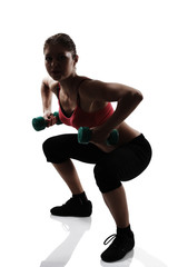 sport young athletic woman doing squatting with dumbbells, silho