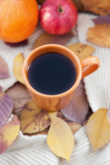 Fototapeta na wymiar Orange coffee cup on the autumn fall leaves