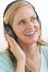 Fototapeta premium Beautiful Woman Enjoying Music Through Headphones