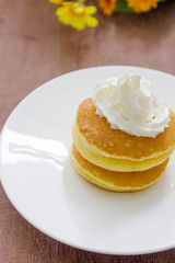 Pancakes with vanilla syrup and whipped cream