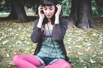 young beautiful woman listening to music autumn