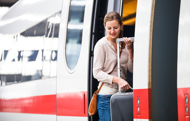 Pretty young woman boarding a train