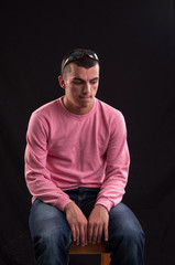 young man with sunglasses sitting on chair