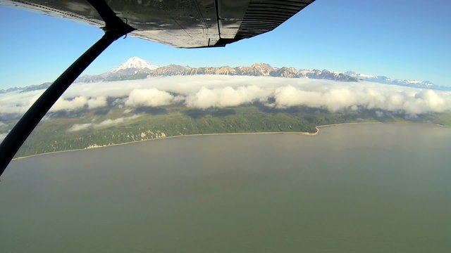 Aerial cloud view of distant Mt Redoubt Volcano Alaskan Wilderness light aircraft, Alaska, USA