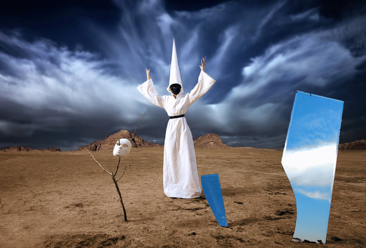 Strange figure in white cloak with mirrors in desert. Artwork