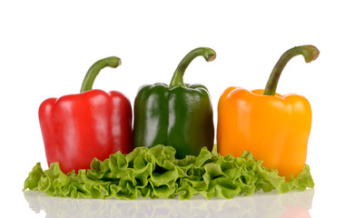 Red Green and Yellow peppers on salad leaf isolated on white bac