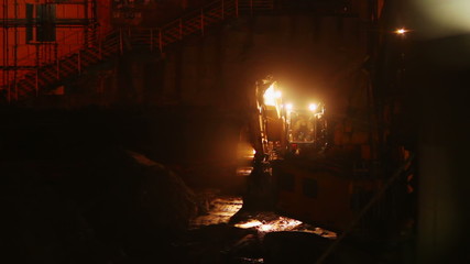 Construction site at night timelapse yellow lights machines work - Powered by Adobe