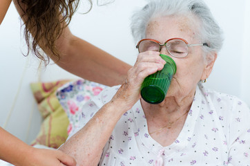 elderly woman drinking water