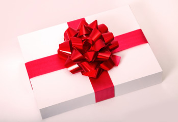 Red gift ribbon with bow on the white box - horizontal