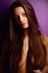 Fototapeta premium Beautiful brunette in a studio