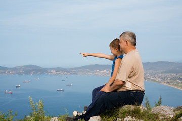 Grandfather and grandson at the top of the mountain.