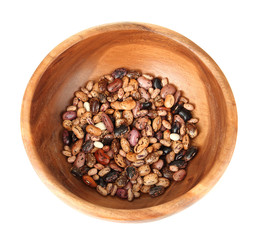 Beans in wooden bowl isolated on white