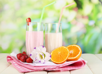 Delicious milk shakes with strawberries and orange