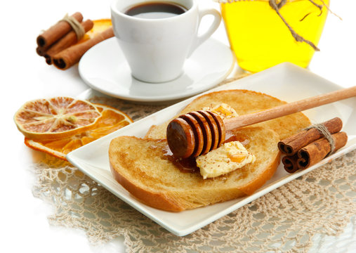 White bread toast with honey and cup of coffee, isolated
