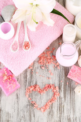 Beautiful spa setting with lily on wooden table close-up