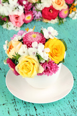 Beautiful bouquet of bright flowers in color vase,